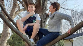 Jeanie J and grandson sitting in tree